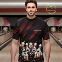 Load image into Gallery viewer, Front view of a male model wearing a black and red bowling quarter zip shirt featuring funny cartoon bowling balls and pins raising frothy beer mugs with confetti and bold diagonal stripe artwork in a bowling lane.