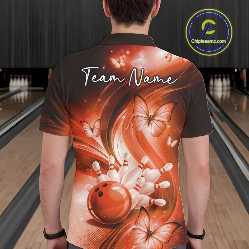 Back view of an orange bowling polo displaying a bowling ball knocking down pins with butterfly details.