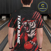 Load image into Gallery viewer, Back view of a male model wearing a black and red bowling polo shirt in a bowling lane, featuring a roaring tiger holding a red bowling ball with red claw-stripe artwork and a geometric background pattern.