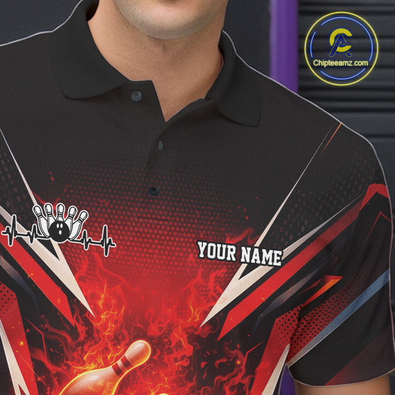 Close-up left chest view of a black and red bowling polo featuring a flaming bowling ball hitting pins.