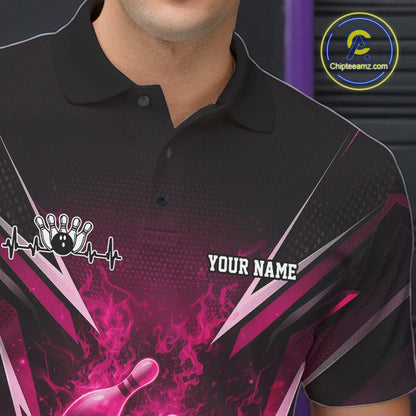 Left chest close-up on a black and pink bowling polo featuring a flaming bowling ball and pin motif.