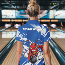Load image into Gallery viewer, Back view of a female model in a bowling alley wearing a blue custom bowling polo shirt with an aggressive crawfish bowling design and a distressed background.
