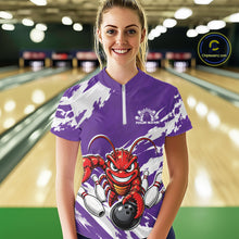 Load image into Gallery viewer, Front view of a happy female model in a bowling alley wearing a purple custom quarter zip bowling shirt with an aggressive crawfish bowling design and a distressed background.