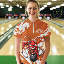 Load image into Gallery viewer, Front view of a happy female model in a bowling alley wearing an orange custom quarter zip bowling shirt with an aggressive crawfish bowling design and a distressed background.
