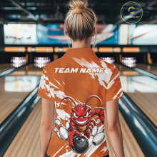 Load image into Gallery viewer, Back view of a female model in a bowling alley wearing an orange custom quarter zip bowling shirt with an aggressive crawfish bowling design and a distressed background.