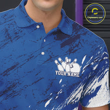 Load image into Gallery viewer, Close up of the left chest area on a white and blue bowling polo shirt featuring a splatter inspired athletic jersey pattern