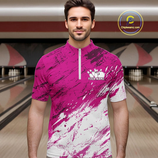 Man wearing a pink and white bowling shirt with a customizable logo in a bowling alley.