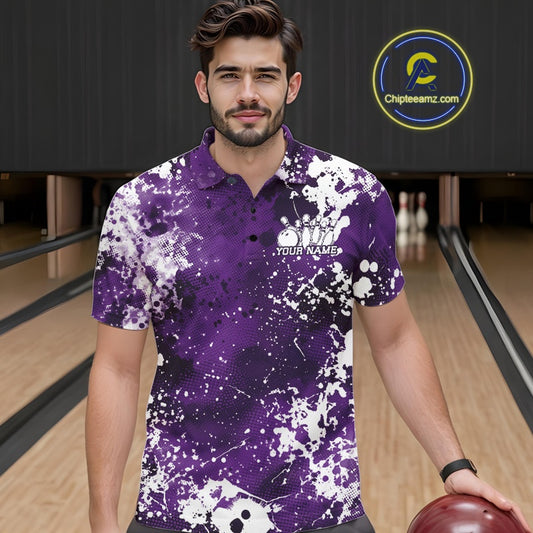 Front view of a male model in a bowling alley wearing a purple bowling polo shirt featuring a white paint splatter sportswear design.
