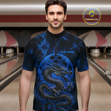Load image into Gallery viewer, Front view of a male model in a bowling alley wearing a blue custom quarter-zip bowling shirt featuring an ancient dragon, flames, and a moon-inspired bowling ball design.