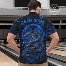 Load image into Gallery viewer, Back view of a male model in a bowling alley wearing a blue custom quarter-zip bowling shirt featuring an ancient dragon, flames, and a moon-inspired bowling ball design.
