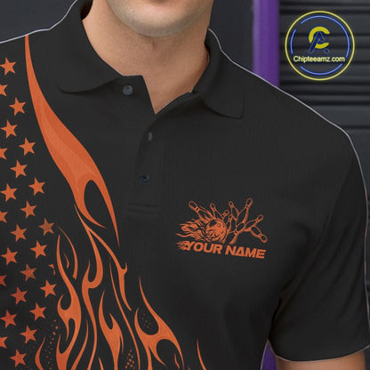 Male model at a bowling lane wearing a black bowling polo shirt with orange flame bowling strike artwork and patriotic graphics.