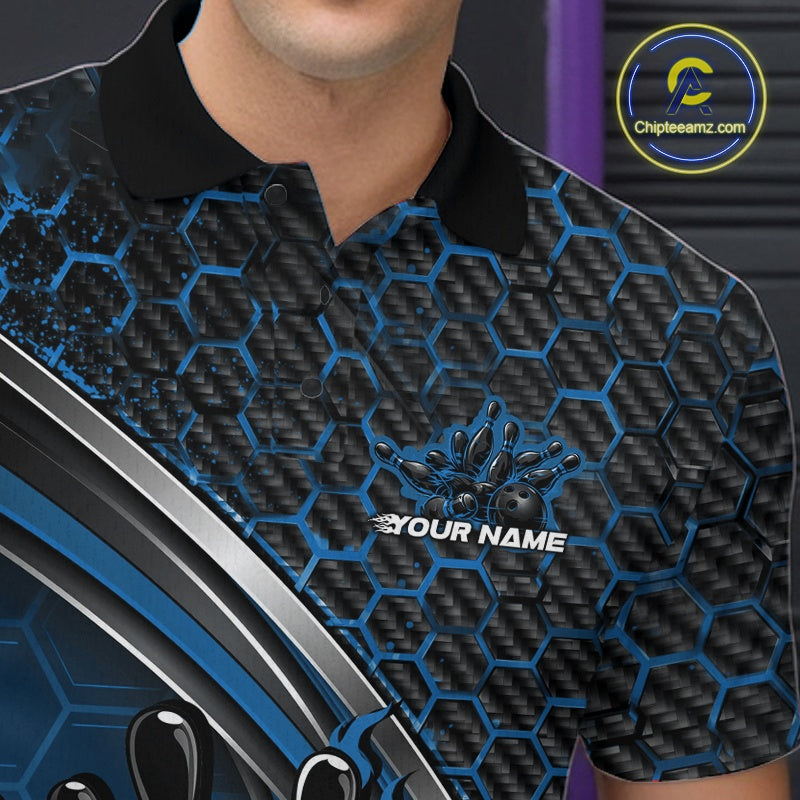 Close-up of the left chest area of a black and blue bowling polo shirt, featuring honeycomb design with a flaming bowling ball hitting pins.
