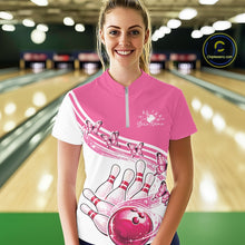 Load image into Gallery viewer, Female model wearing a white and pink bowling quarter zip with butterfly artwork and bowling graphics, front view inside a bowling alley