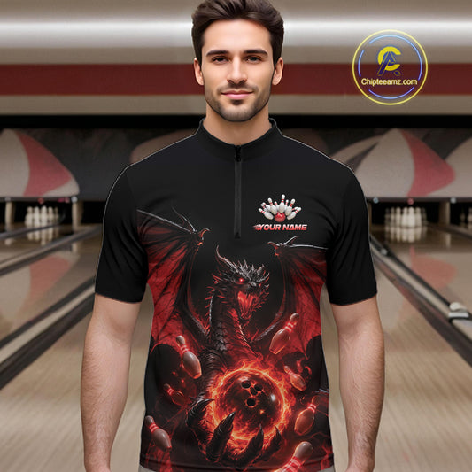 A man wearing a black short-sleeve bowling quarter zip shirt jersey with a red and black dragon graphic and a custom name print on the chest, set against a bowling alley background.