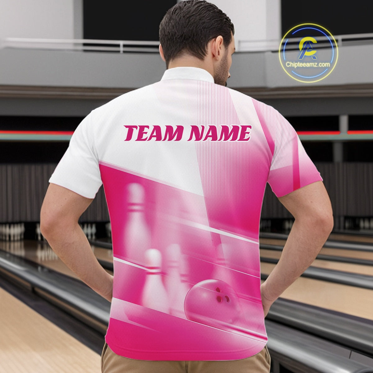 Front view of a male model in a bowling lane wearing a white and pink quarter zip shirt with bowling ball and pins geometric artwork.