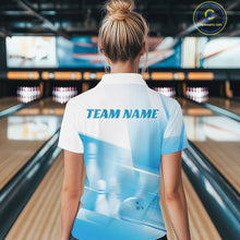 Load image into Gallery viewer, Back view of a female model in a bowling lane wearing a white and blue polo shirt with bowling ball and pins in a pink geometric pattern.
