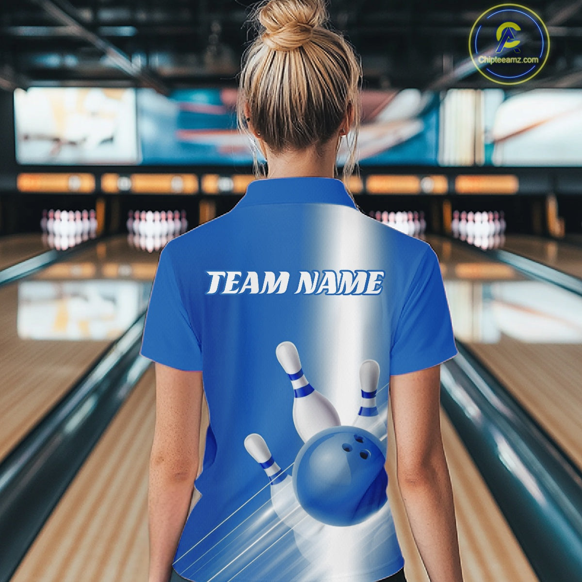 Female model back view in a bowling lane wearing a quarter zip shirt with bowling ball and pins flowing through a blue gradient pattern.