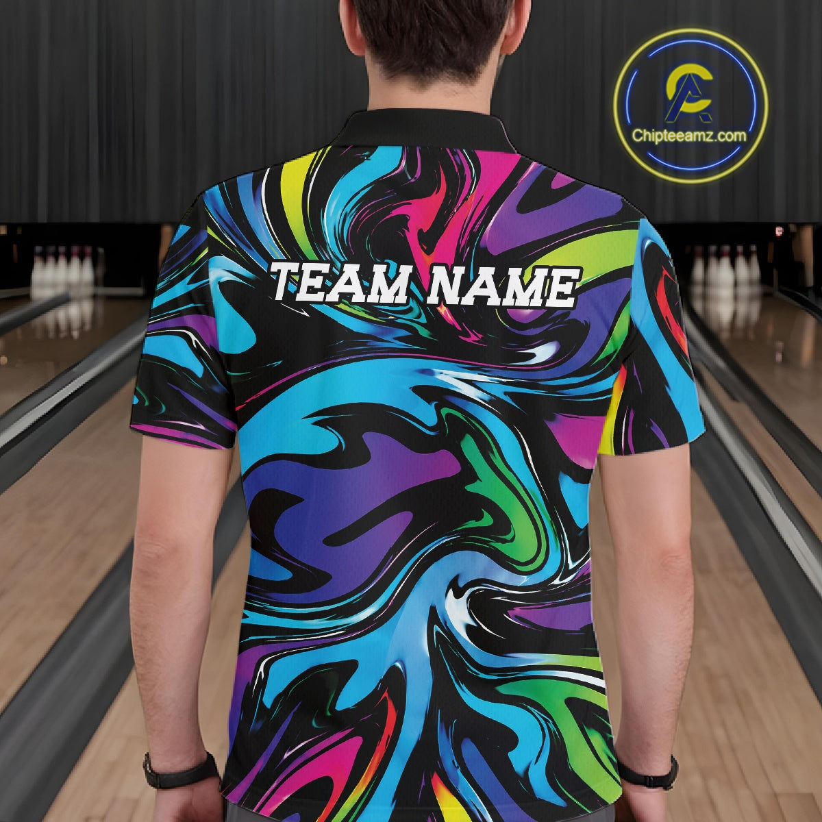 Person wearing a colorful bowling shirt with 'TEAM NAME' text in a bowling alley.