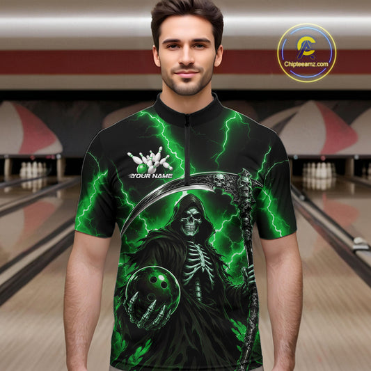A man wearing a black short-sleeve quarter-zip bowling jersey with a green and black grim reaper graphic, standing in front of a blurred bowling alley background. The jersey features green lightning bolts, a skeleton, a bowling ball, and a white logo on the chest.