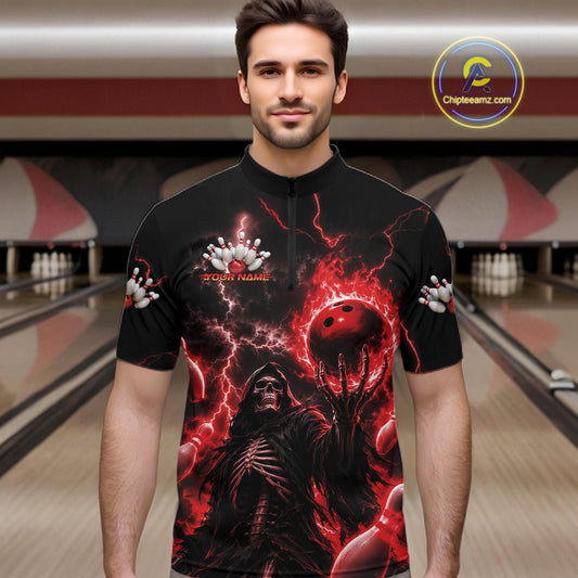 A man wearing a black short-sleeve bowling-themed graphic shirt with a red and black horror design, standing in front of a bowling alley background. The shirt features a skull, bowling pins, lightning, and a red bowling ball.