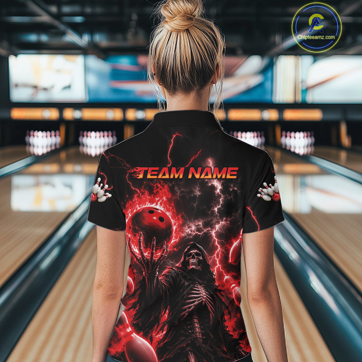 A woman viewed from behind wearing a black short-sleeve bowling shirt with a dramatic red and black graphic print featuring lightning, a bowling ball, and the text 'TEAM NAME' on the back.
