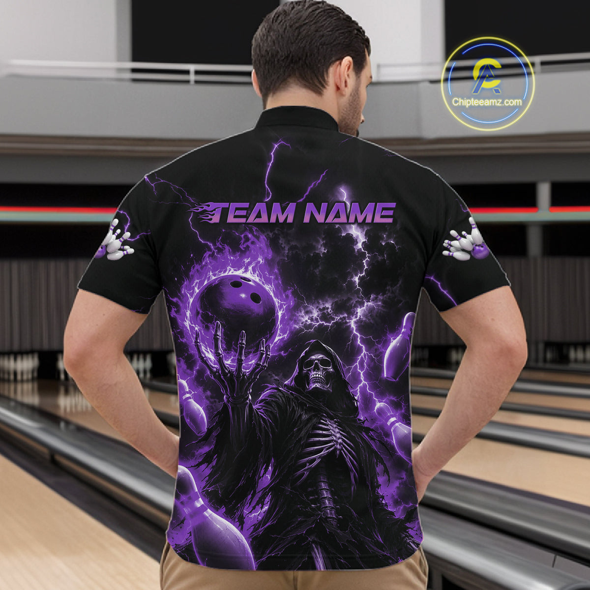 A man viewed from behind wearing a black short-sleeve bowling shirt with a large purple and black graphic print featuring a skeletal figure, bowling ball, lightning, and the text 'TEAM NAME' on the back.