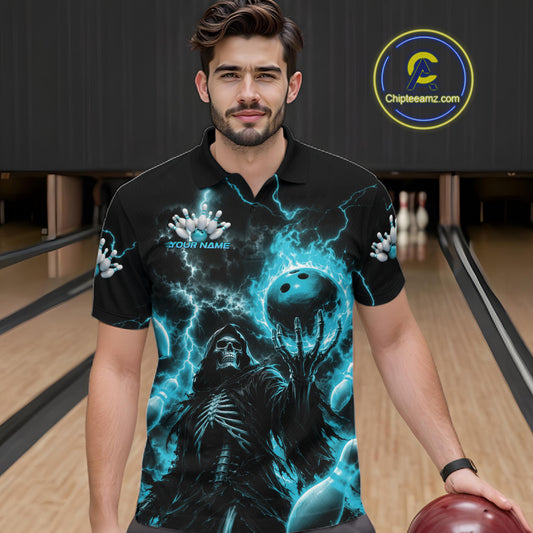 A man wearing a black short-sleeve polo shirt with a detailed graphic print of a skeleton and a bowling ball surrounded by blue lightning, standing in a bowling alley.