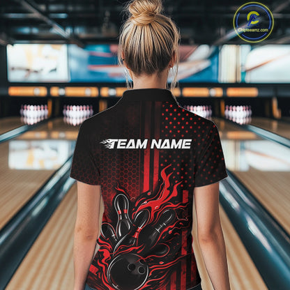 Back view of a female model in a bowling alley wearing a black and red polo featuring bowling pins and flaming bowling ball artwork.