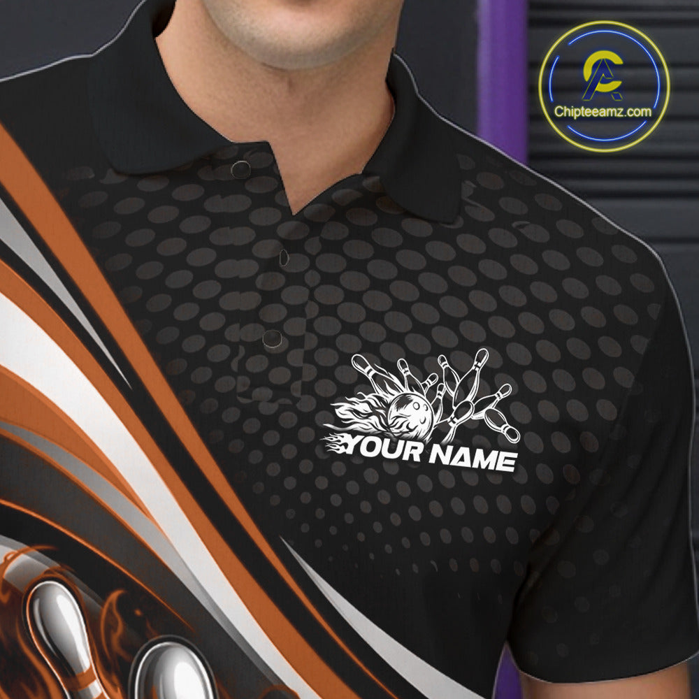 Close-up view of left chest area of a black and orange polo shirt, showing small flame bowling ball and pins graphic detail.