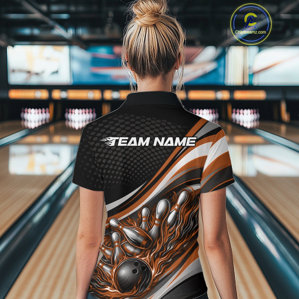 Back view of a female bowler wearing a black and orange polo shirt, flame bowling ball hitting pins with bold action graphics.