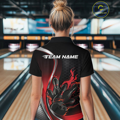 Female model back view in bowling center wearing black and red polo shirt showcasing flame bowling ball striking pins in bold dynamic artwork.