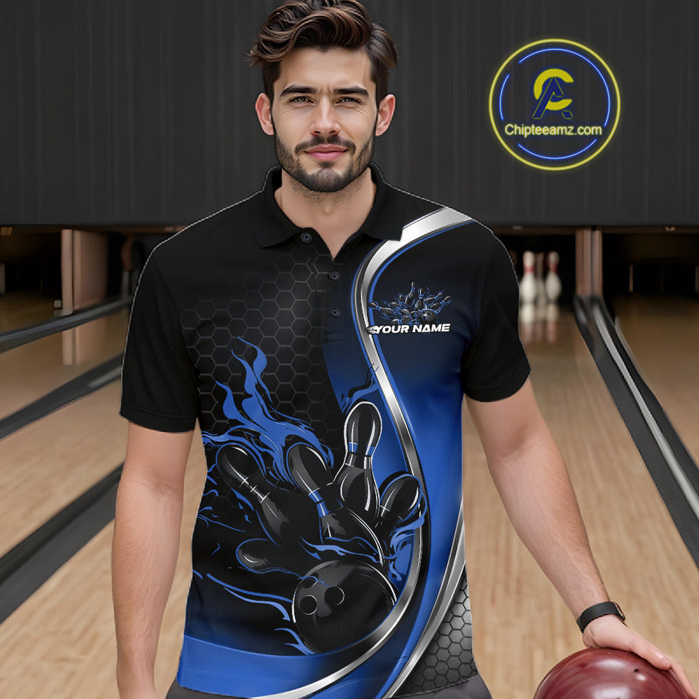Male model seen from the front in a bowling lane wearing a black and blue polo shirt featuring a flame bowling ball striking pins in a dynamic sports scene.