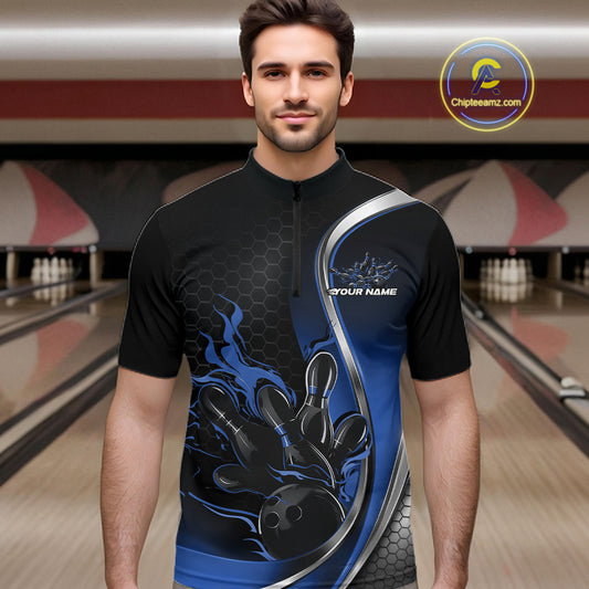 Male model front view in bowling alley wearing black and blue quarter zip shirt showcasing flame bowling strike artwork