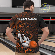 Load image into Gallery viewer, Male model wearing a black and orange bowling quarter-zip shirt in a bowling alley featuring a tribal flame bowling ball and pins graphic