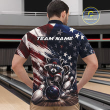 Load image into Gallery viewer, Front view of a male model at a bowling lane wearing a bowling quarter-zip shirt with a raccoon in patriotic sunglasses rolling a bowling ball through scattered pins and a distressed American flag backdrop.