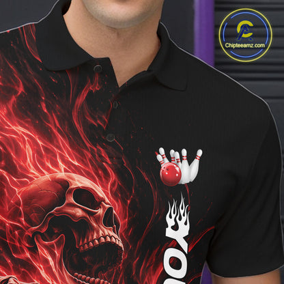 Close-up of the left chest on a black bowling polo shirt featuring a skull clutching a bowling ball engulfed in swirling red energy flames