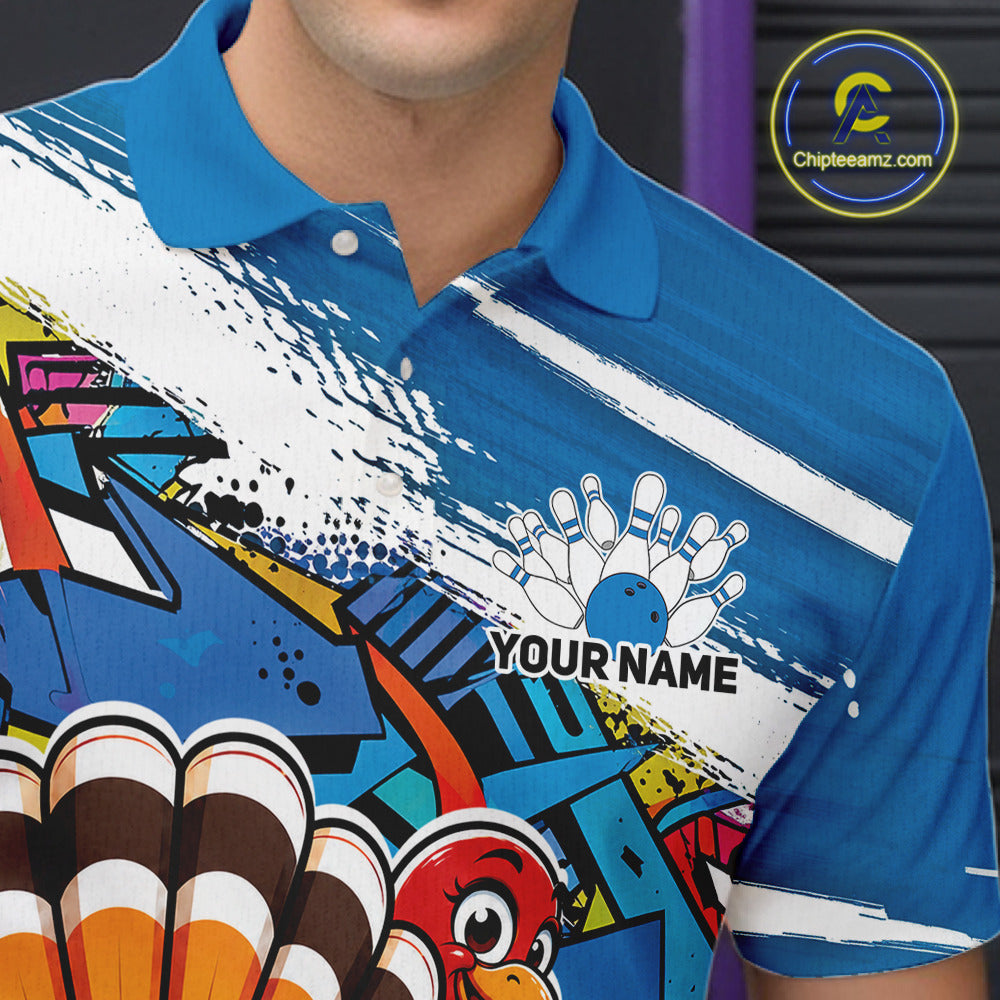 Close up front view of the left chest area on a blue custom bowling polo shirt, featuring a graffiti inspired urban street style design with paint splatter accents and a personalized name.