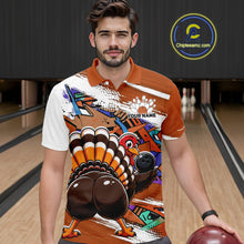 Load image into Gallery viewer, Front view of a male model wearing an orange custom bowling polo shirt featuring a funny graffiti style turkey holding a bowling ball, paint splatter details, and a custom name in a bowling alley.