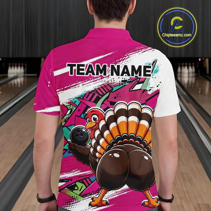 Back view of a male model wearing a pink custom bowling polo shirt with a funny graffiti turkey holding a bowling ball, paint splatter accents, and a personalized name in a bowling alley.