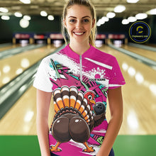Load image into Gallery viewer, Front view of a happy female model in a bowling alley wearing a pink custom quarter zip bowling shirt with a funny graffiti turkey holding a bowling ball, paint splatter accents, and a personalized name.