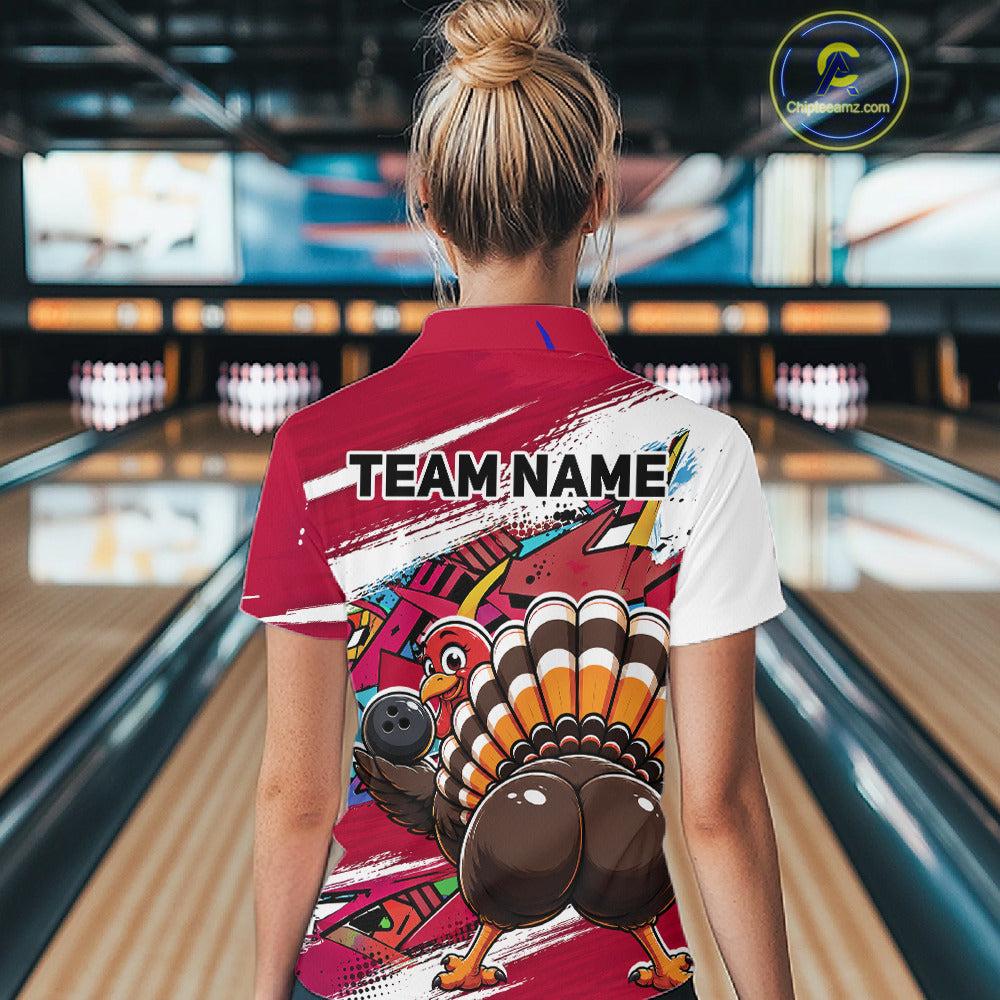 Back view of a female model in a bowling alley wearing a red custom quarter zip bowling shirt with a funny graffiti turkey holding a bowling ball, paint splatter accents, and a personalized name.