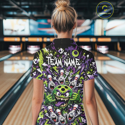 Back view of a female model in a bowling lane wearing a green and purple bowling quarter-zip shirt showcasing a mischievous green monster bowling ball with sharp teeth, a purple tongue, playful hand gesture, and cheerful cartoon bowling pins.