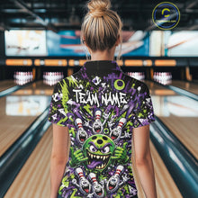 Load image into Gallery viewer, Back view of a female model in a bowling lane wearing a green and purple bowling quarter-zip shirt showcasing a mischievous green monster bowling ball with sharp teeth, a purple tongue, playful hand gesture, and cheerful cartoon bowling pins.