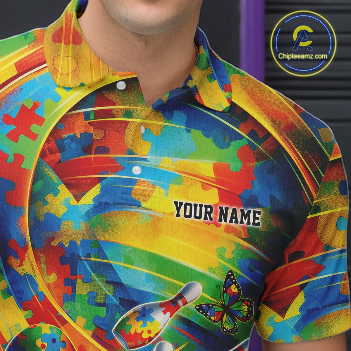 Close-up left chest detail of colorful bowling polo shirt featuring autism puzzle ribbon and bowling-themed emblem design