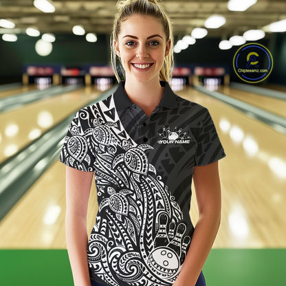 Female model wearing a black and white bowling polo shirt at the lane with turtle-inspired bowling graphics.