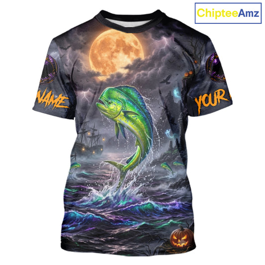 A short-sleeve crewneck t-shirt featuring a full-bleed Halloween graphic print. The design depicts a green and yellow mahi-mahi fish jumping from dark, stormy ocean waves under a large orange full moon, with a ghost ship in the background and customizable text placeholders 'NAME' and 'YOUR' on the sleeves.