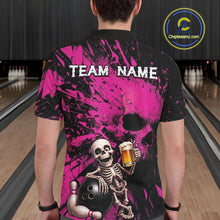 Load image into Gallery viewer, Person wearing a black and pink bowling shirt with a skeleton design in a bowling alley.