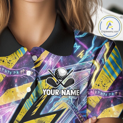 Close-up of a person wearing a short-sleeve polo shirt with a black collar and a vivid all-over graphic print in purple, blue, yellow, and black. The shirt has a golf-themed chest graphic with a golf ball, crossed clubs, and the text 'YOUR NAME,' indicating personalization.