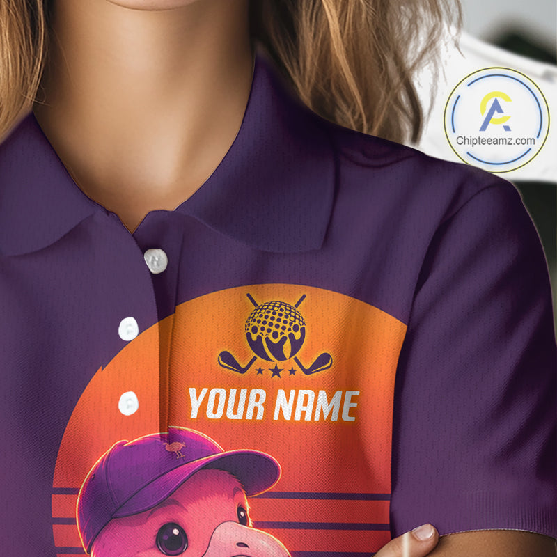 Purple polo shirt with a graphic of a bear wearing a cap and text 'YOUR NAME' on an orange background.