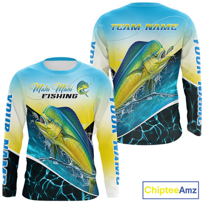 A long-sleeve crewneck fishing shirt with a vibrant Mahi Mahi fish graphic on the front, a blue-to-yellow gradient background, and 'Mahi Mahi FISHING' text across the chest. The sleeves feature 'YOUR  NAME' branding.